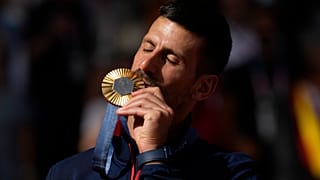 Serbia's Novak Djokovic kisses his gold medal after defeating Spain's Carlos Alcaraz during the men's singles tennis final at the Paris Olympics. Sunday, Aug. 4,
