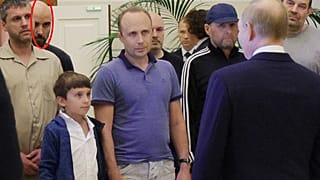 A man identified as Pablo González, a freelance journalist from Spain who had been based in Poland since 2019, second from left with shaved head, listens to Russian President