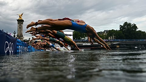 Athletes compete in the swimming race in the Seine during the women's individual triathlon at the 2024 Summer Olympics, Wednesday, July 31, 2024 in Paris, France.