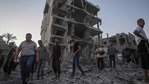 Des Palestiniens se tiennent dans les décombres après une frappe aérienne israélienne à Deir al Balah, dans la bande de Gaza, le mardi 6 août 2024. 