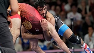 Greece's Dauren Kurugliev and Iran's Hassan Yazdanicharati compete during their men's freestyle 86kg quarterfinal wrestling match, at Champ-de-Mars Arena