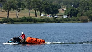 A jet ski pulls in buoys from the CrossFit Games at Marine Creek Lake, where an athlete drowned during the run swim event on Thursday, Aug. 8, 2024 in Fort Worth, Texas