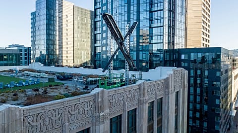 An "X" sign rests atop the company headquarters in downtown San Francisco, on July 28, 2023
