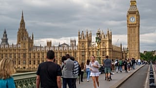 People walk on Westminster Bridge in London.