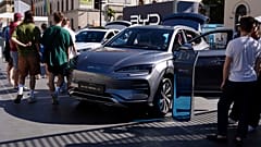Visitors watch a BYD Seal U car at the IAA motor show in Munich, Germany, Friday, Sept. 8, 2023.