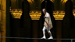 Philippe Petit walks a tightrope inside the Cathedral Church of St. John the Divine to mark the 50th anniversary of his World Trade Center Twin Towers high-wire walk