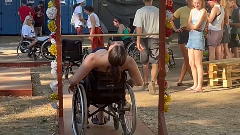 A festival-goer partakes in the wheelchair obstacle course