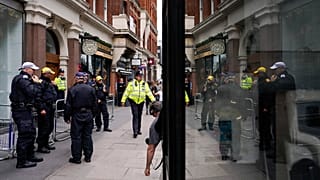 Police officers patrol outside the London offices of the political party Reform UK, ahead of an anti-far right protest, in London, Saturday, Aug. 10, 2024.