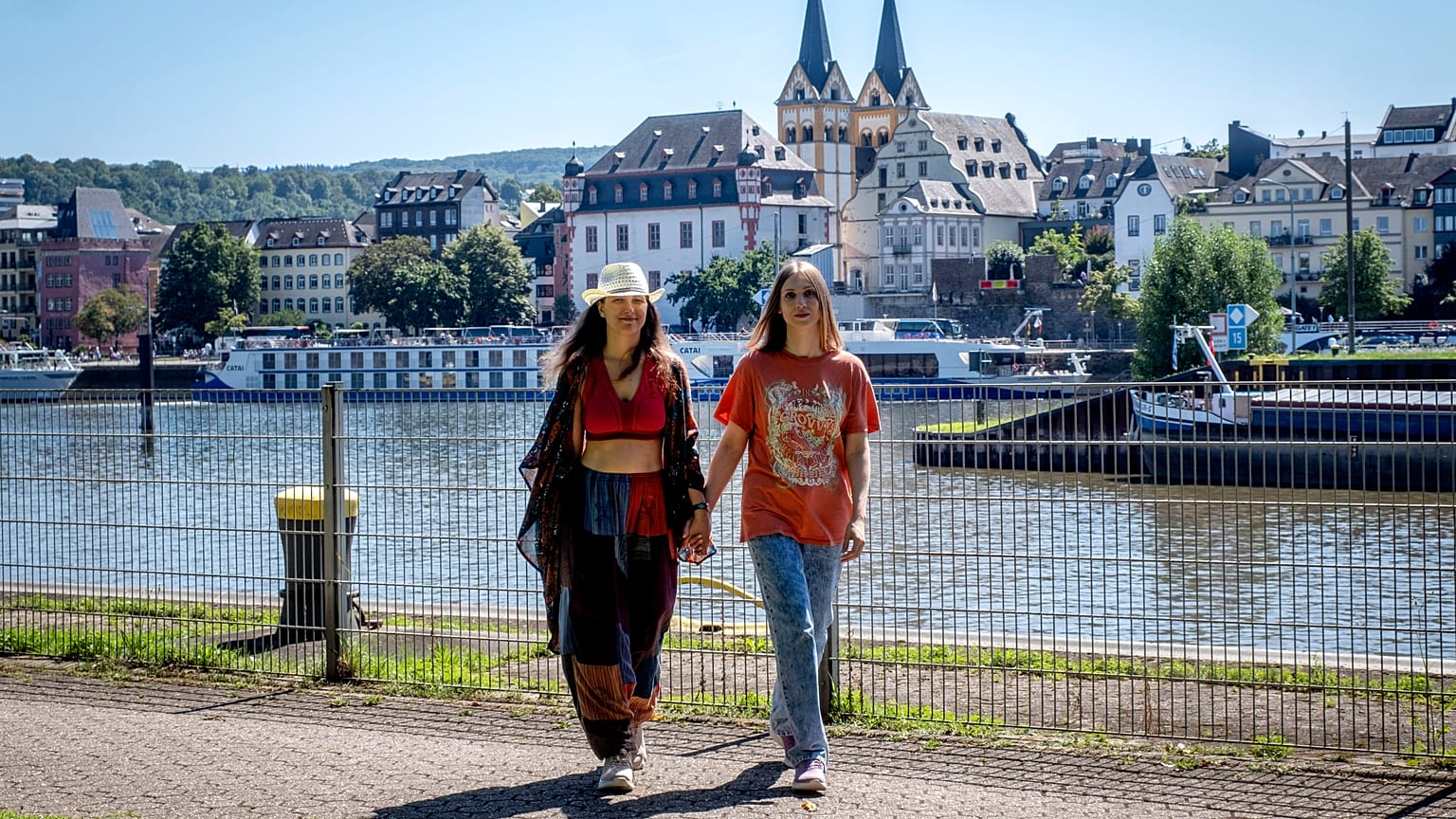 Freed Russian artist Sasha Skochilenko and her partner, Sonya Subbotina, walk at the banks of the Mosel River in Koblenz.