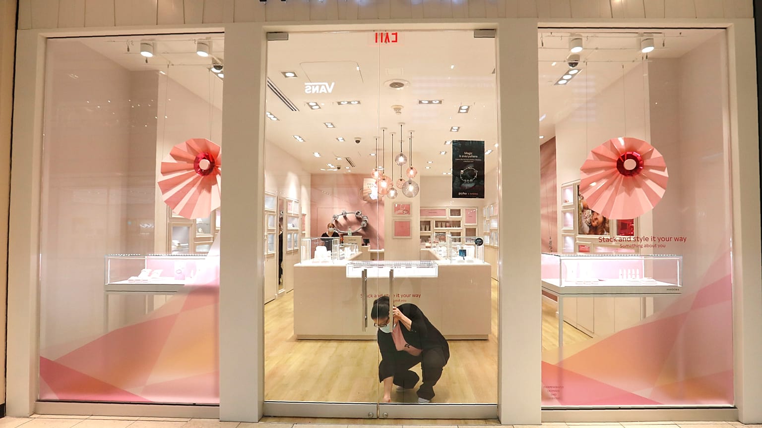 Tania Lima unlocks the glass doors opening a Pandora retail store in the Galleria Dallas mall in Dallas, Monday, May 4, 2020. 