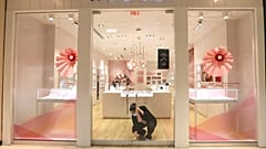 Tania Lima unlocks the glass doors opening a Pandora retail store in the Galleria Dallas mall in Dallas, Monday, May 4, 2020. 