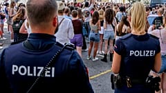 Police officers stand near gathering swifties in Vienna on Friday, Aug.9, 2024.