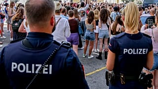 Police officers stand near gathering swifties in Vienna on Friday, Aug.9, 2024.