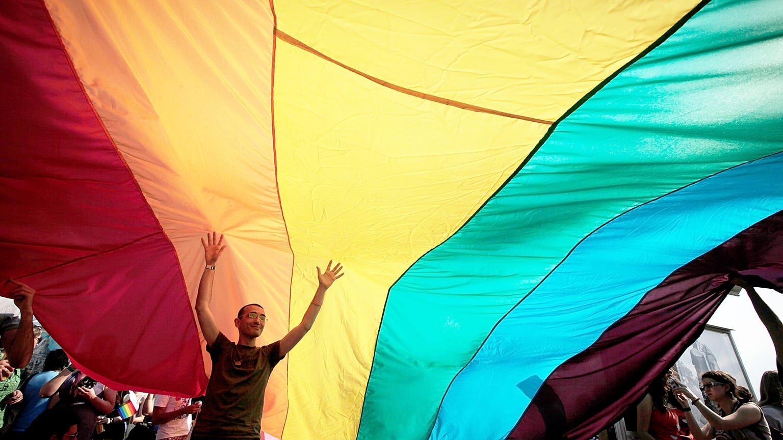 FILE: Young Bulgarian is seen underneath the rainbow flag during the the fourth gay pride rally in the Bulgarian capital of Sofia, 18 June 2011