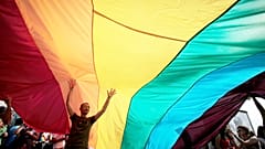 FILE: Young Bulgarian is seen underneath the rainbow flag during the the fourth gay pride rally in the Bulgarian capital of Sofia, 18 June 2011