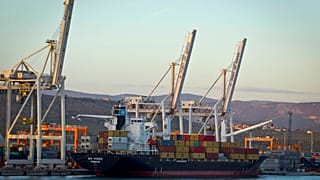 Cranes and a cargo ship are seen in the port of Koper, Slovenia. Sept. 25, 2012.