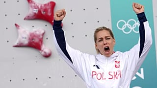 Gold medallist Aleksandra Miroslaw of Poland celebrates on the podium after winning the women's speed climbing final at the 2024 Olympics, Aug. 7, 2024, in Le Bourget, France