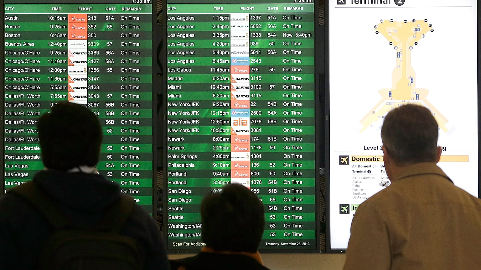 A group looks at the departures board in the domestic terminal at San Francisco International Airport in San Francisco, Thursday, Nov. 28, 2013.
