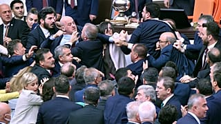 Lawmakers scuffle during an extraordinary session of the Turkish Grand National Assembly to debate the case of jailed opposition lawmaker Can Atalay, August 16, 2024