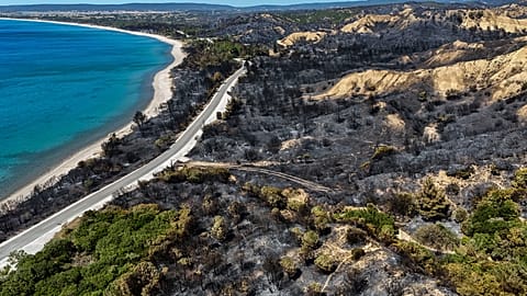 An aerial shot shows part of the extinguished wildfire area at the Anzac Cove beach, the site of World War I landing of the ANZACs (Australian and New Zealand Army Corps).