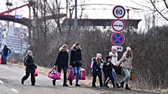 Ukrainian refugees crossing the border into HUngary the day after Russia's full-scale invasion on 24 February 2022