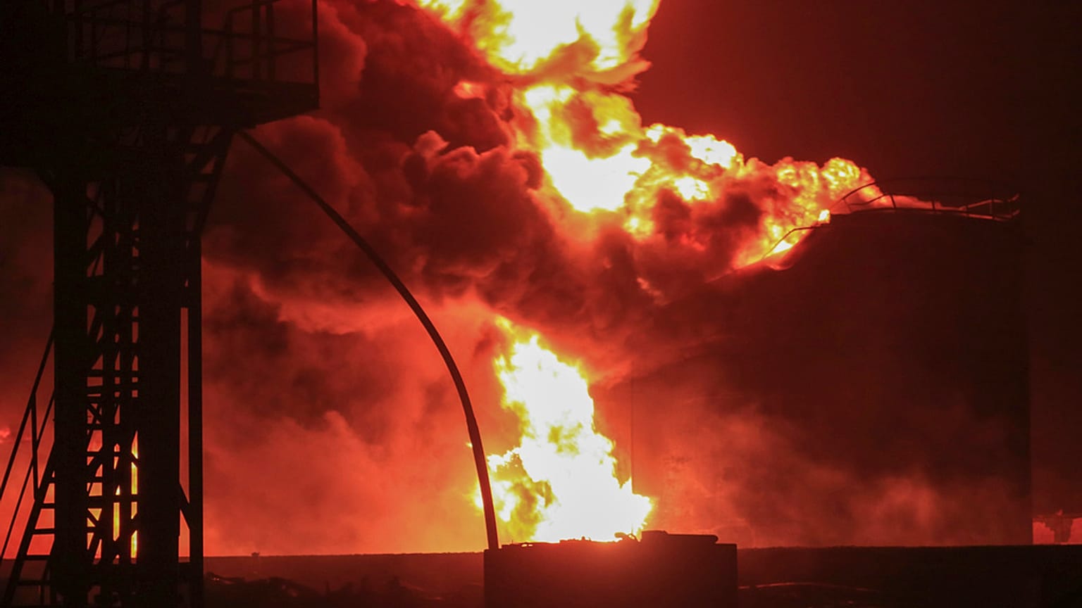 Oil tanks burn at the port in Hodeidah, Yemen, Saturday, July 20, 2024. 