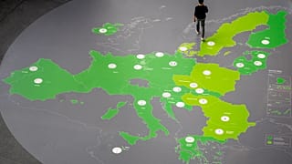 A man walks on a map showing the countries of the Eurozone in the hallway of the European Central Bank in Frankfurt.