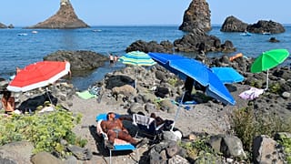 Holidaymakers at the beach in Aci Trezza, near Catania in Sicily 