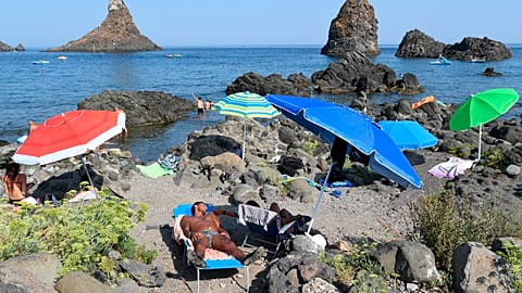 Holidaymakers at the beach in Aci Trezza, near Catania in Sicily 