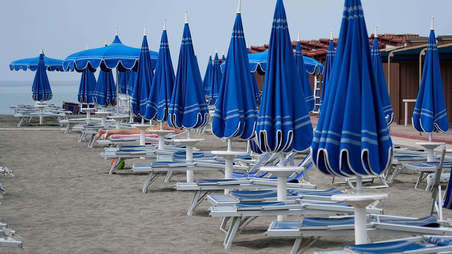 Umbrellas and sun beds are set at the Venezia beach establishment in Ostia, near Rome. 16 August, 2024.