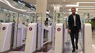 A man goes through an automated gate at Dubai Airport, in the United Arab Emirates, Sunday March 7, 2021. 