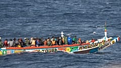 Migrants crowd a wooden boat as they sail to the port in La Restinga on the Canary island of El Hierro, Spain, Monday, Aug. 19, 2024. 