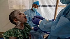 A health worker takes a saliva sample from Lucie Habimana, 13, a mpox patient, at a treatment centre in Munigi, eastern Congo, Friday, August 16, 2024.