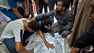 Palestinians mourn a relative killed in the Israeli bombardment of the Gaza Strip, at a hospital in Khan Younis, Saturday, Aug. 24, 2024. 
