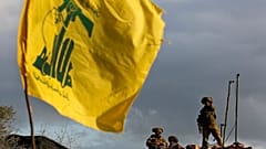  جنود إسرائيليون يقفون للحراسة بجوار الكاميرات في موقعهم الجديد أمام علم حزب الله، بالقرب من قرية ميس الجبل الحدودية الجنوبية اللبنانية، يوم الخميس، 13 ديسمبر، 2018.