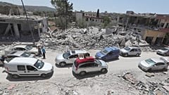 FILE: People inspect their destroyed houses that were hit by an Israeli airstrike, in Aita al-Shaab village, south Lebanon, 29 June 2024