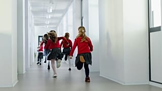 Primary school students running to class