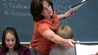 Counselor Kelley Peel, center, hands out copies of the students book they wrote and illustrated entitled "Kid's Cancer Storys" in Muskegon, June 3, 2008.