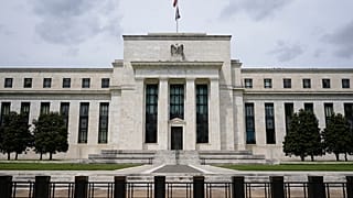 An American flag flies over the Federal Reserve building, Tuesday, May 4, 2021, in Washington.
