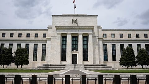 An American flag flies over the Federal Reserve building, Tuesday, May 4, 2021, in Washington.