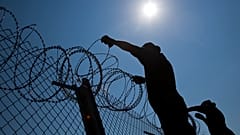 А��хив: венгерские пограничники натягивают колючую проволоку на границе с Сербией, август 2015 г.