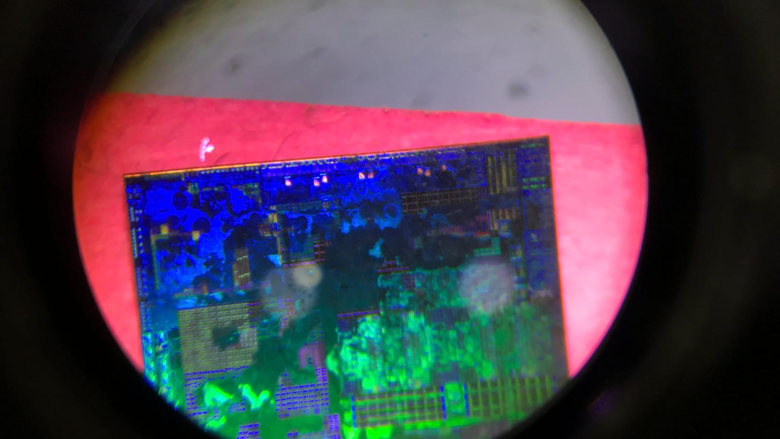 A Chinese microchip is seen through a microscope set up at the Tsinghua Unigroup project booth during the China Beijing International High-tech Expo on May 17, 2018. 