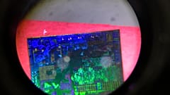 A Chinese microchip is seen through a microscope set up at the Tsinghua Unigroup project booth during the China Beijing International High-tech Expo on May 17, 2018. 