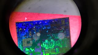 A Chinese microchip is seen through a microscope set up at the Tsinghua Unigroup project booth during the China Beijing International High-tech Expo on May 17, 2018. 