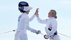 Italy's Elena Micheli and Britain's Kerenza Bryson cheer after competing in the final fencing bonus round in the women's pentathlon at the 2024 Olympics, 11 August 2024