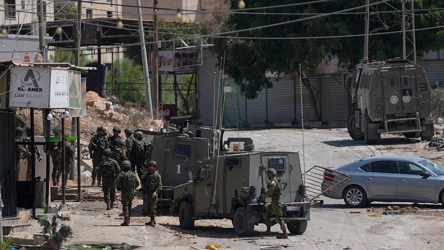 Members of Israeli forces patrol a street during a military operation in the West Bank refugee camp of Al-Faraa, Wednesday, Aug. 28, 2024.