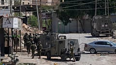 Members of Israeli forces patrol a street during a military operation in the West Bank refugee camp of Al-Faraa, Wednesday, Aug. 28, 2024.
