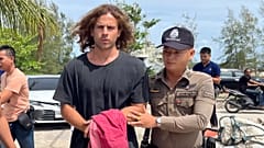 Taylandlı bir polis memuru, Daniel Sancho Bronchalo'ya eşlik ediyor. 