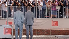 Brad Pitt, left, and George Clooney pose for photographers upon arrival for the press conference of the film 'Wolfs'