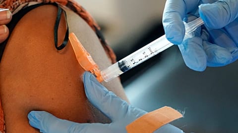 A nurse gives a COVID-19 vaccine to an unidentified person in the US, 2021.